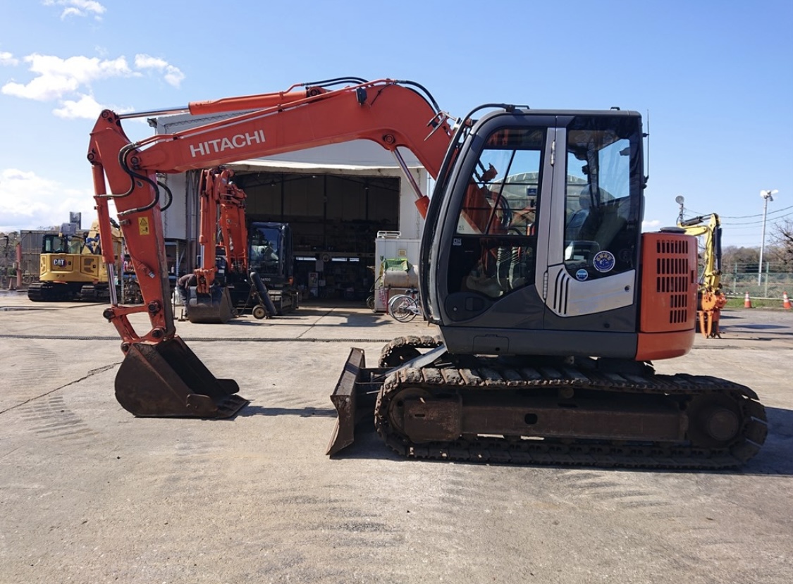 Used Hitachi mini excavator parked at a Japanese equipment yard